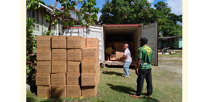 Men unpacking truck with PPE in PNG