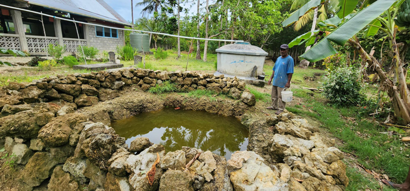 Peter Wale Collecting Water From A Well In Surabuta