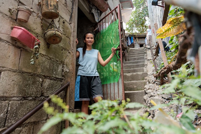 Ronita (22) outside her small home in Quezon City, Philippines. Photo: Richard Wainwright/Caritas Australia 