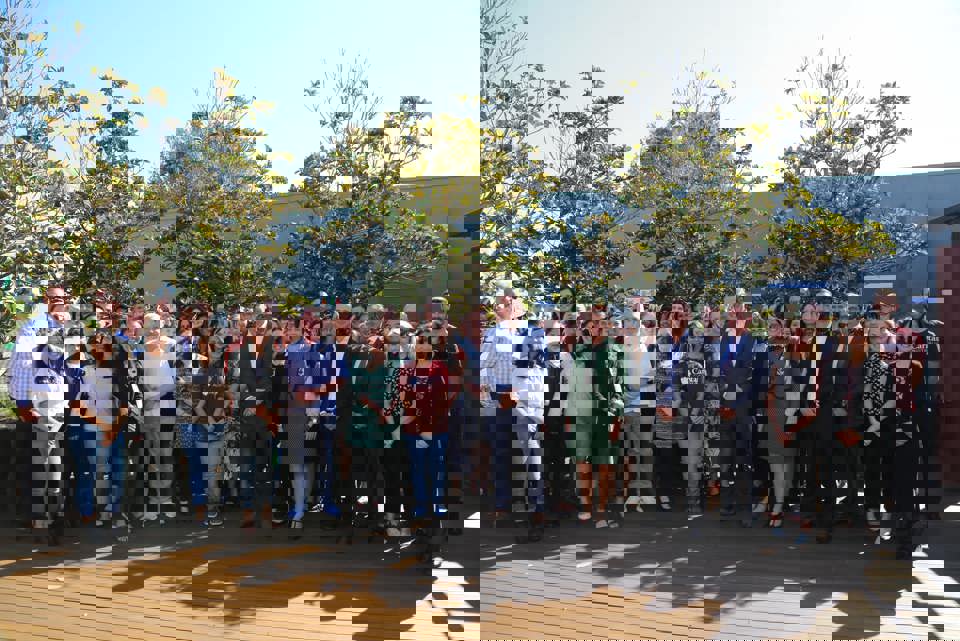 Minister with NGO staff in courtyard in Australia
