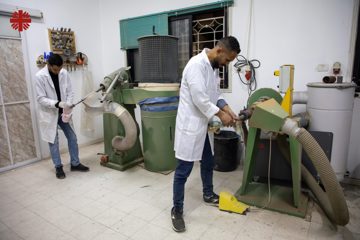 Two Specialists Work On Brightly Coloured Prosthetic Sockets Designed For Children Photo Credit Caritas Jerusalem