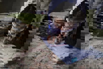 A young girl in Afghanistan studies.