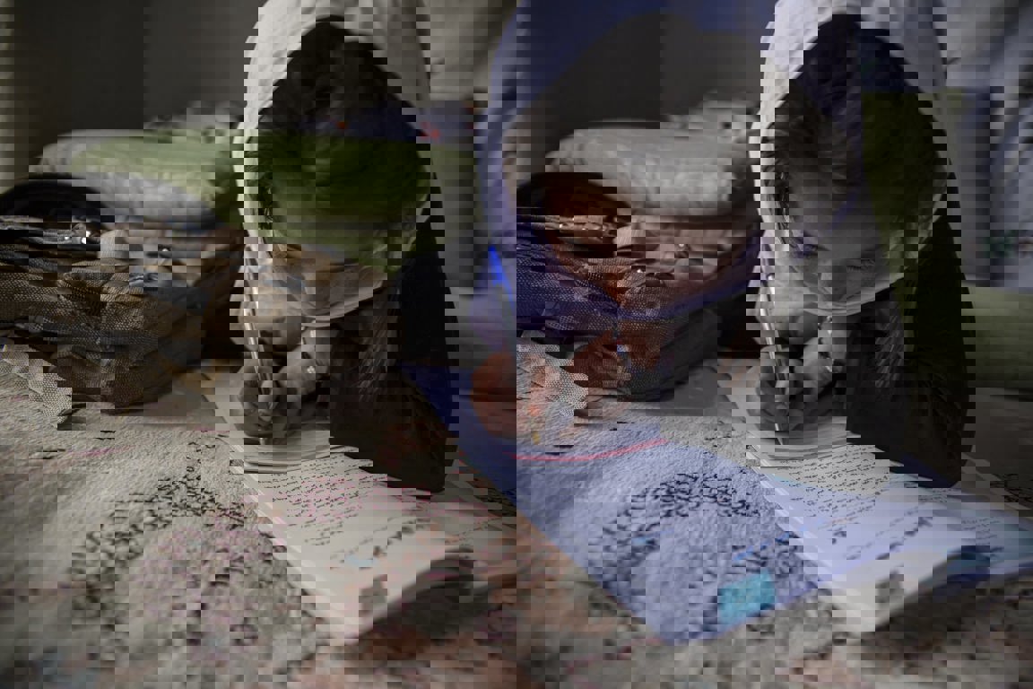 A young girl in Afghanistan studies.