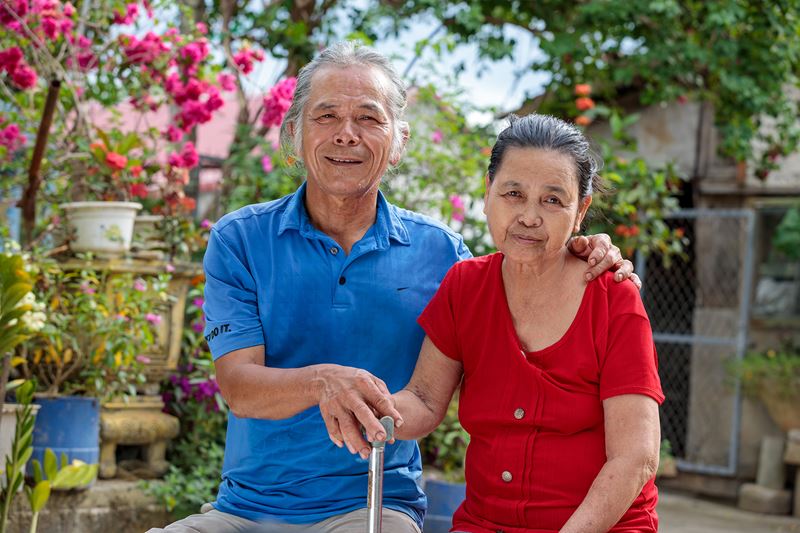 Thu And His Wife Linh Outside Their Home